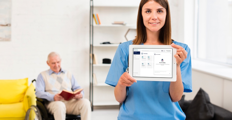 Healthcare assistant holding a tablet with the Knowledge interface on it.