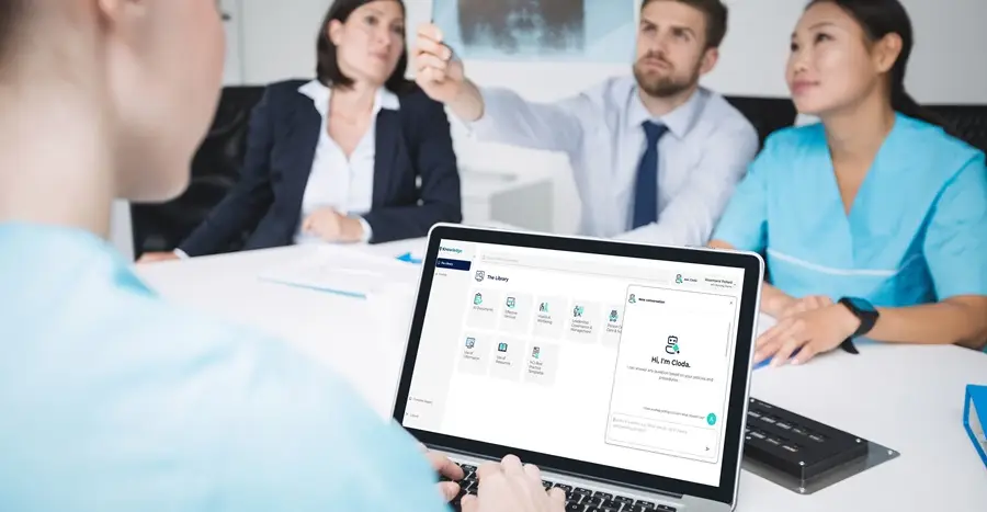 nurses in meeting looking at laptop