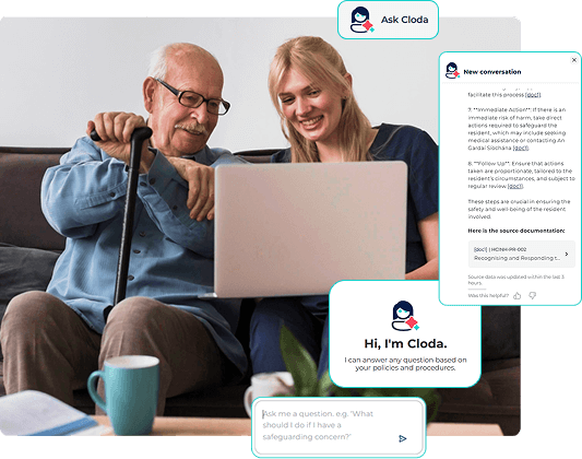 nurse and elderly resident looking at a laptop